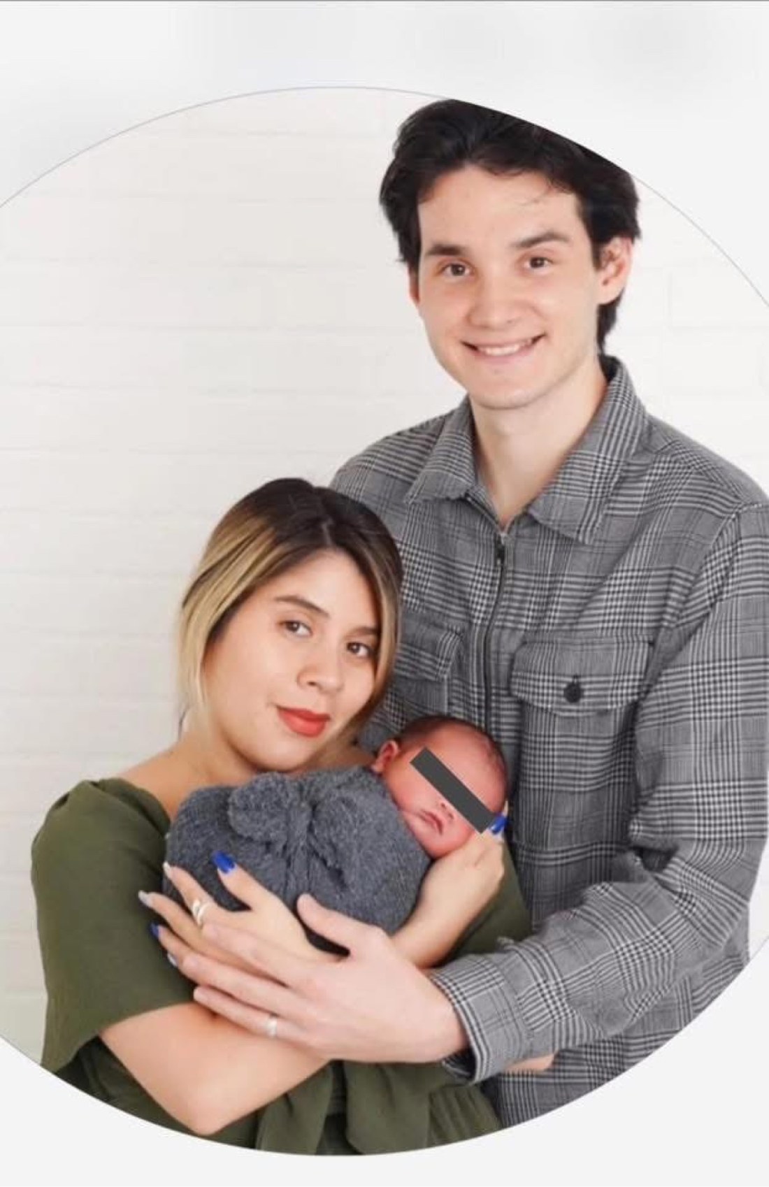 Valeria Hacket and Joshua Hacket holding their newborn baby, whose face is covered